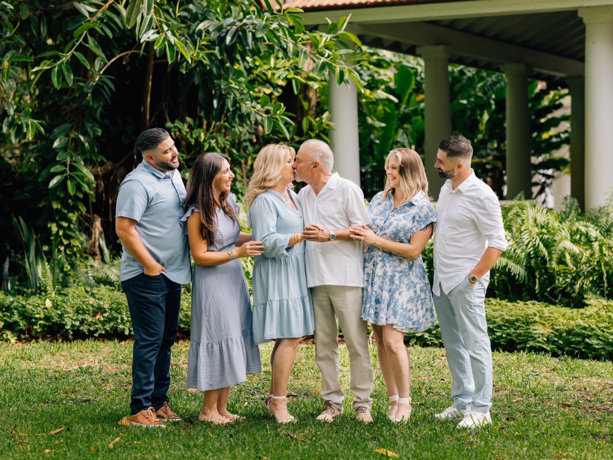Family gathered close together, photographed by Four Little Birds Photography in Miami