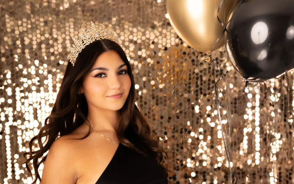 Close-up quinceañera portrait against a gold sequin backdrop
