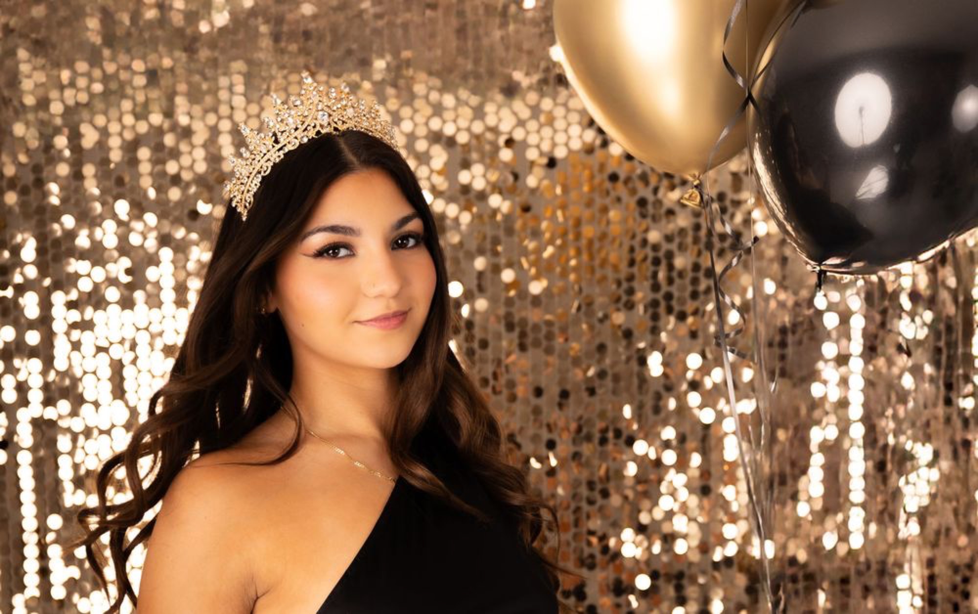 Close-up quinceañera portrait against a gold sequin backdrop