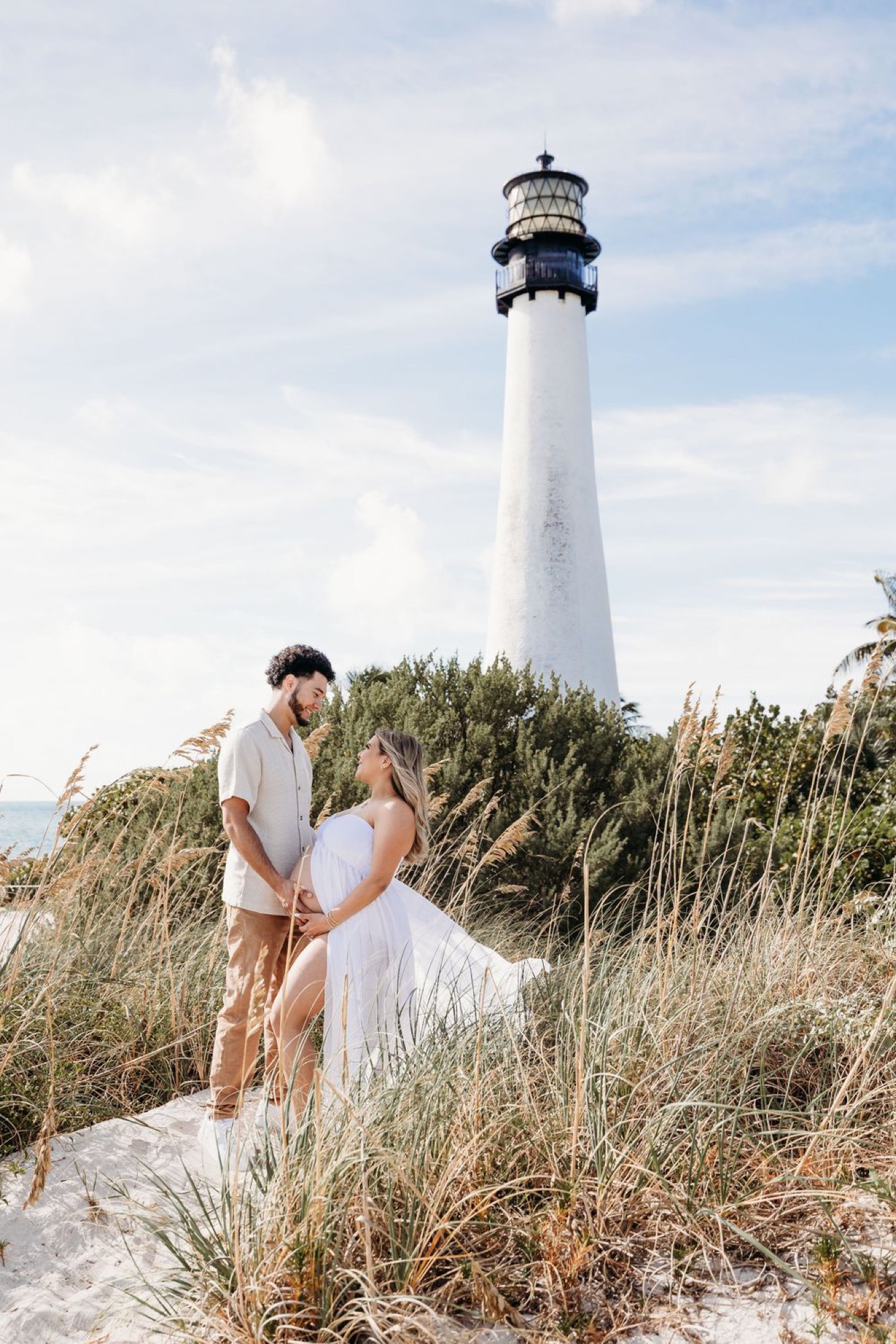 Engaged couple sharing a moment at the Cape Florida lighthouse