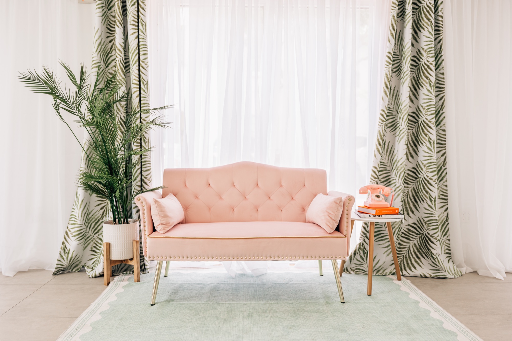 Palm Springs inspired pink loveseat set inside the Four Little Birds studio