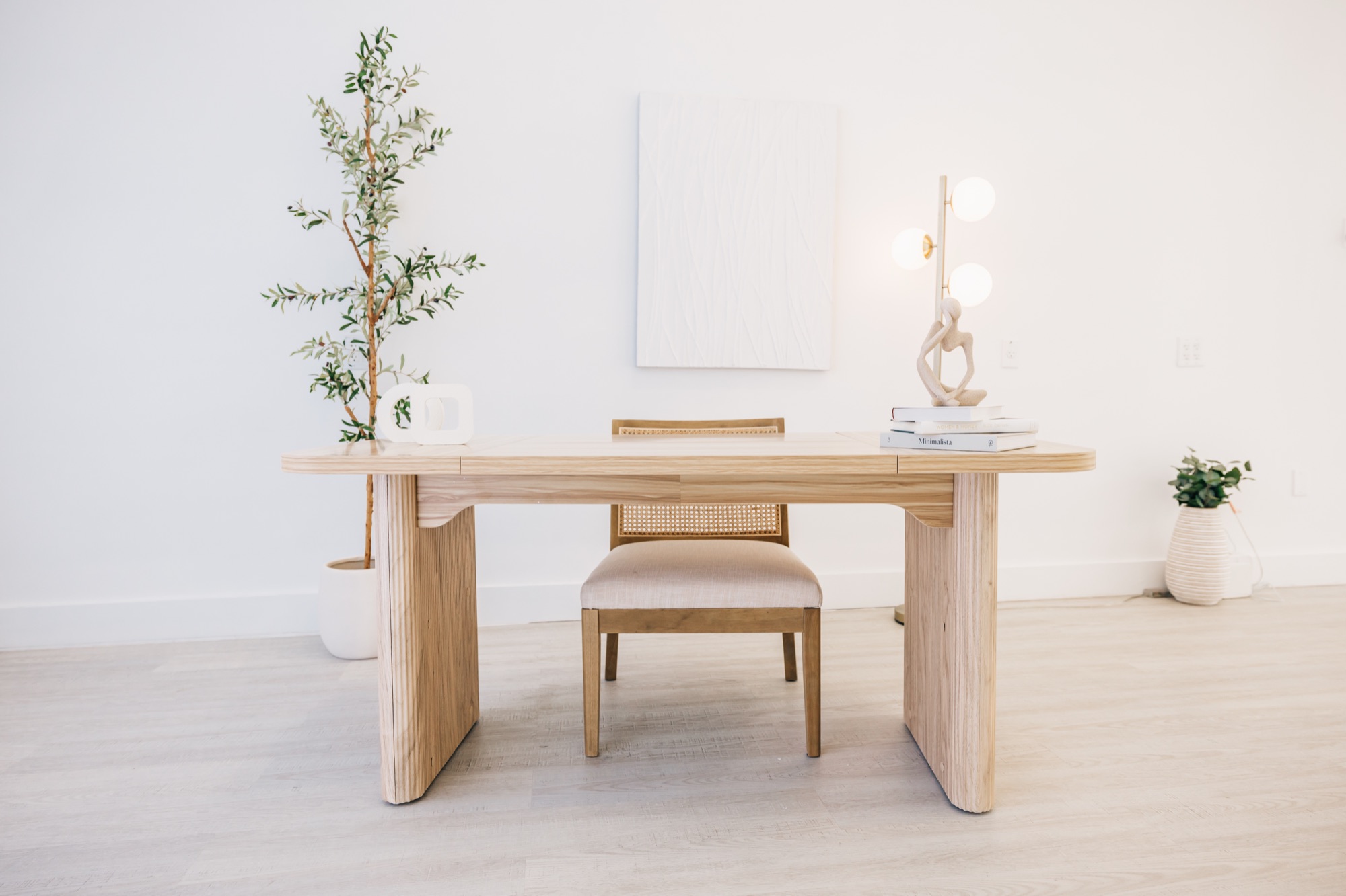 Branding desk with cane chair and warm lamp inside the Four Little Birds studio